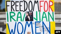 A poster held during a march in Paris on September 15, one day before the second anniversary of the death in police custody of Mahsa Amini, which sparked a protest movement in Iran.