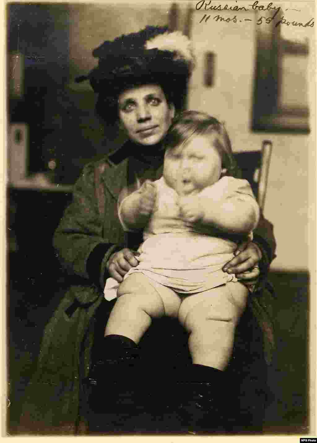 A Russian mother with her baby. At the time of the photo, the child was 11 months old and weighed 55 pounds (25 kilograms).