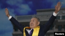 Kazakh President Nursultan Nazarbaev greets his supporters during a postelection rally in Astana.