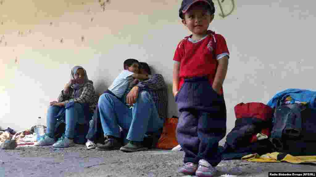 Children and parents rest at a train station in Demir Kapija on their way to the Serbian border on June 15.&nbsp;​Macedonia&#39;s Interior Ministry says the number of illegal migrants has quadrupled in the past four months. Thousands of migrants are now entering the country every week, officials say.