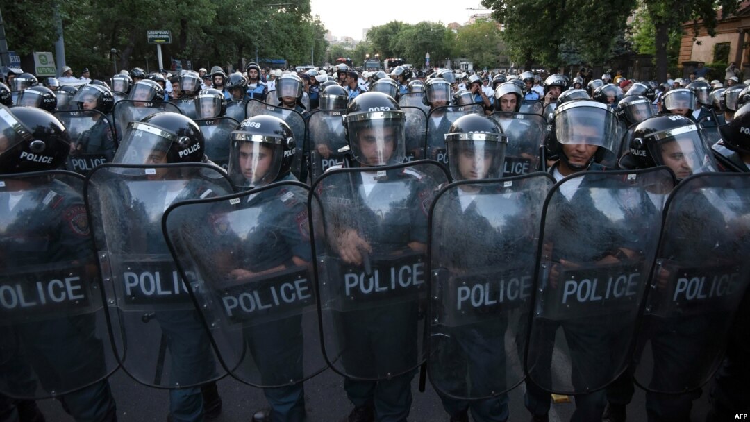 Armenia -- Police block a street during a protest against an increase of electricity prices in Yerevan, June 23, 2015