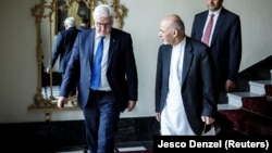 Afghan President Ashraf Ghani (right) welcomes German counterpart Frank-Walter Steinmeier to the Gulkhana-Palace in Kabul on July 13.