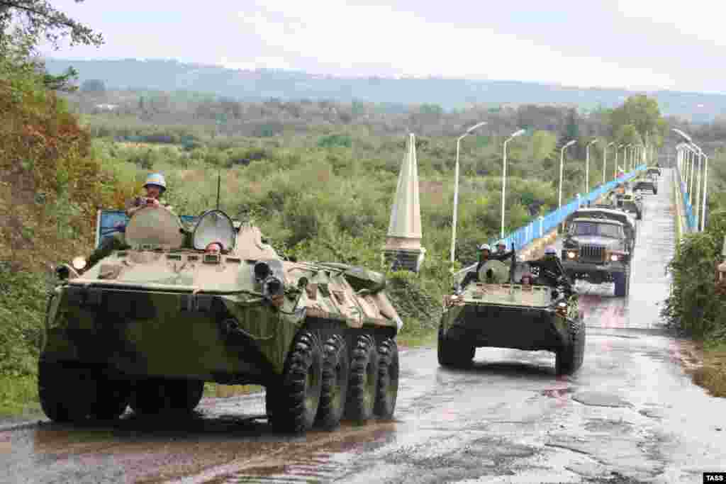 A column of Russian armored vehicles withdraws through Rukhi, Georgia, on its way to Abkhazia in October 2008. After recognizing Abkhaziaand Soth Ossetia, Russia built a number of military bases in the two regions, and also protects their borders and supports both regions financially. Abkhazia and South Ossetia have been effectively turned into Russian dependencies.