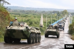 A column of Russian armored vehicles travels through Rukhi, Georgia, on its way to Abkhazia in October 2008.