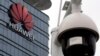 FILE PHOTO: A surveillance camera is seen in front of the Huawei logo outside its factory campus in Dongguan, Guangdong province, China, March 25, 2019. REUTERS/Tyrone Siu/File Photo