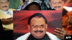 Supporters of Pakistan's Muttahida Qaumi Movement (MQM) party hold photographs of party leader Altaf Hussain as they stage a sit-in calling for his release in Karachi on June 3.