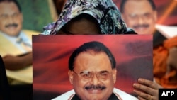 Supporters of Pakistan's Muttahida Qaumi Movement party hold photographs of party leader Altaf Hussain as they stage a sit-in calling for his release in Karachi on June 3, 2014.