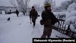 Ukrainian soldiers patrol an area in the government-held village of Travneve on November 23.