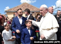 Pope Francis meets with members of the Roma community in the Barbu Lautaru district of Blaj, Romania, on June 2.