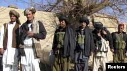 Afghanistan -- Taliban militants stand, after voluntarily handing over their weapons and joining the government, in Sangin district of Helmand Province, 01Jan2011