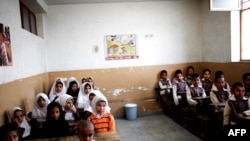 Afghan schoolchildren attend a class at the Shahid Nasseri refugee camp in Taraz Nahid village near the city of Saveh, some 130 kms southwest of the capital Tehran (file photo).