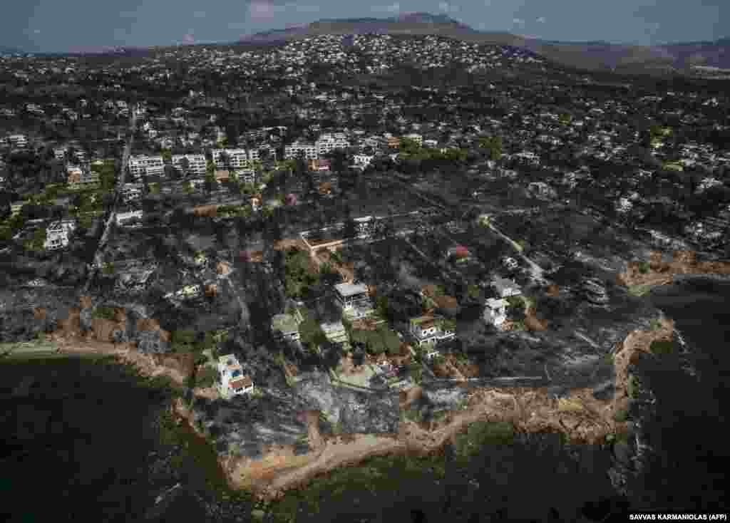 An aerial view shows a scorched area following a wildfire in the village of Mati, near Athens. Greece was counting the cost of its deadliest wildfires in living memory, as emergency crews searched incinerated homes and vehicles for the missing after at least 81 people were confirmed to have died. (AFP/Savvas Karmaniolas)