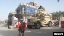 FILE: An Afghan soldier stands guard at the entrance of a government compound in Farah Province, western Afghanistan May 15, 2018.