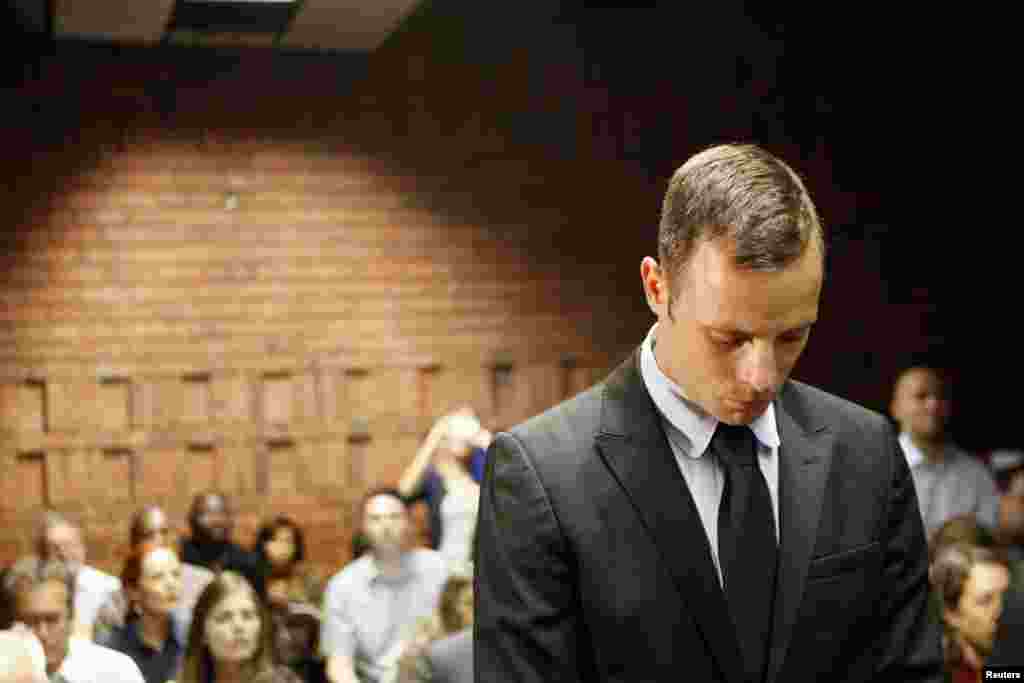 Paralympic athlete Oscar Pistorius stands in the dock during a break in court proceedings at the Pretoria Magistrates Court. Pistorius was applying for bail after being charged in court with shooting dead his girlfriend, 30-year-old model Reeva Steenkamp, in his Pretoria house. (Reuters/Siphiwe Sibeko)