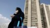 A pedestrian wearing a face mask crosses a street in northern Tehran on March 1.