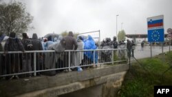 Migrants wait to be allowed to enter Slovenia, at the Croatian-Slovenian border in Trnovec on October 19.