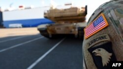 U.S. military vehicles are unloaded from a transport ship in the harbor in Bremerhaven, Germany, on January 6.