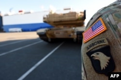 U.S. military vehicles are unloaded from a transport ship in the harbor in Bremerhaven, Germany, on January 6.