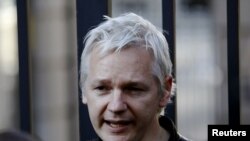 WikiLeaks founder Julian Assange speaks to protesters outside St Paul's Cathedral, next to the London Stock Exchange, in central London, on October 15.