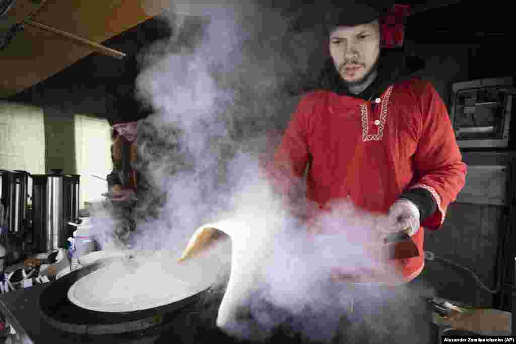 A performer bakes pancakes for guests during Maslenitsa in Moscow.