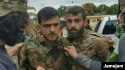 A photo allegedly showing a member of Iran's Islamic Revolutionary Guards Corps after being captured by opposition forces in Syria.