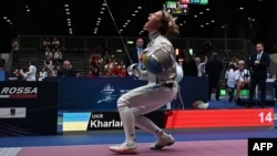 Ukraine's Olha Kharlan celebrates after defeating Russia's Anna Smirnova (not in picture) during the World Fencing Championships in Milan on July 27.