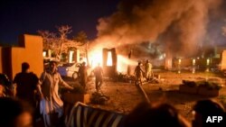 Security personnel and firefighters arrive at the site of the explosion in Quetta on April 21. 