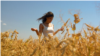 Moldova, Farmer Cristina Bejereanu in a wheat field, wheat