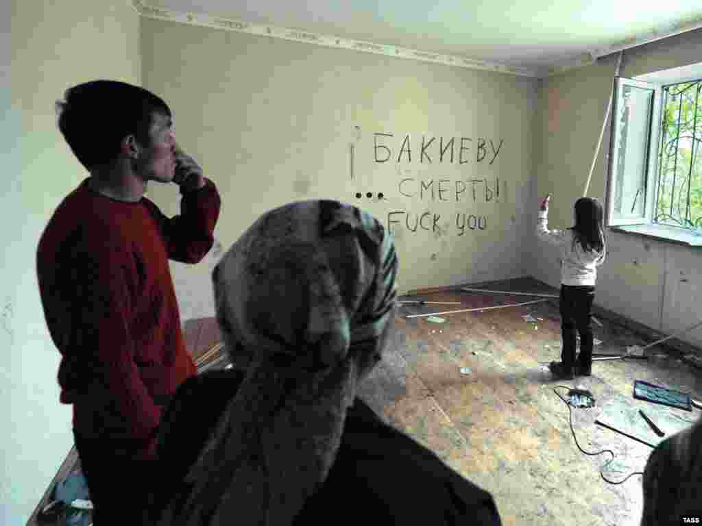 People stand inside the looted house of ousted President Kurmanbek Bakiev, who fled the capital for his home town of Jalal-Abad.