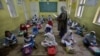 Students attend a class on the first day of primary school after the resumption of classes in Peshawar on September 30.