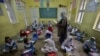 Students attend a class in Peshawar during the first day of primary school after the resumption of classes on September 30.