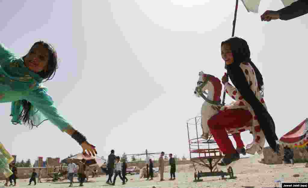 Afghan children ride on a carousel during Eid al-Fitr celebrations in Kabul.