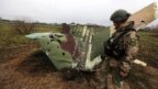 A military sapper inspects remains of a downed Russian Sukhoi Su-25 jet in the Kyiv region on April 21.