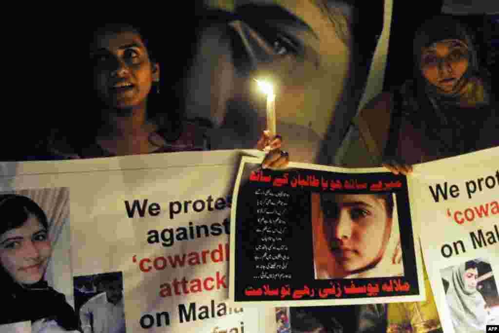 Civil society activists carry candles to pay tribute to Malala in Lahore.