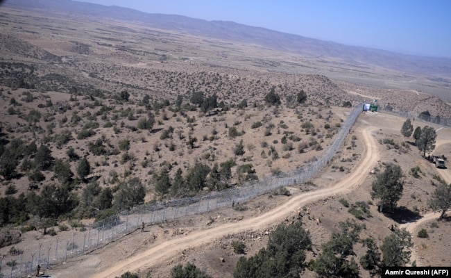 Pakistani soldiers patrol the newly fenced border next to Afghan's Paktika Province border in Pakistan's South Waziristan.