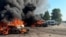 Vehicles burn after a Russian strikes on the town of Pechenihy in the Kharkiv region that killed at least 10 people on August 18. 