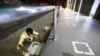 A man paints areas to maintain social distancing outside a shopping center in Karachi after the Pakistani government eased lockdown restrictions on May 17.