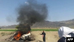  A car is seen on fire at the site of a drone strike believed to have killed Afghan Taliban leader Mullah Akthar Mansur in southwest Pakistan on May 21.