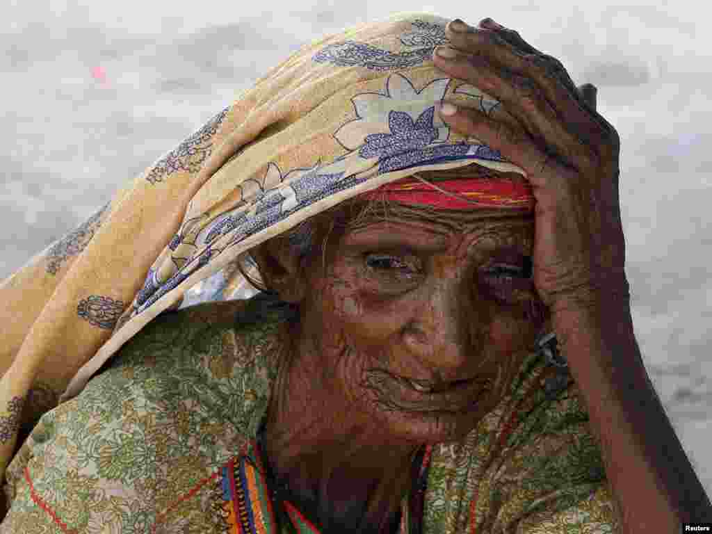 Bibi Nooran, who has been displaced by floods, takes refuge at a roadside makeshift camp for flood victims in Sujawal, some 29 kilometers from Thatta in Pakistan's Sindh Province, on October 27. Photo by Akhtar Soomro for Reuters