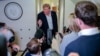 US President Donald Trump speaks to reporters aboard Air Force One on his return to the United States following a visit to Ireland.