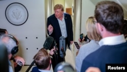 US President Donald Trump speaks to reporters aboard Air Force One on his return to the United States following a visit to Ireland.