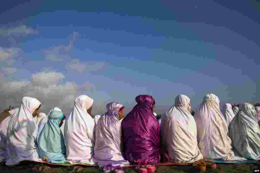 Indonesian women pray near the coast in Bantul, Yogyakarta, on the island of Java.