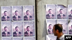Election posters plastered on a wall in Iraq, January 2009.