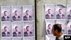 Iraq -- Election posters plasters of Omar Faruq al-Ani, one of the three candidates who were killed, Baghdad, 30Jan2009 