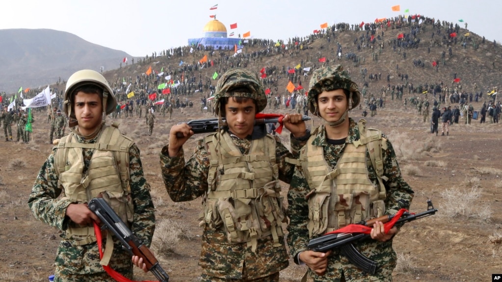  Basij members pose for a picture during a military exercise outside the holy city of Qom in central Iran.
