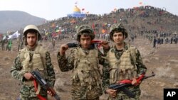 Basij members pose for a picture during a military exercise outside the holy city of Qom in central Iran.