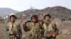 In this Friday, Nov. 20, 2015 photo released by the Fars News Agency, members of the Basij, the paramilitary unit of Iran's Revolutionary Guard, pose for a picture during a military exercise outside the holy city of Qom, central Iran. Thousands of paramil