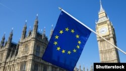 Generic – European Union flag hanging in front of Big Ben and the Houses of Parliament at Westminster Palace, London, in preparation for the Brexit EU referendum