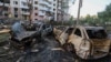 Burned-out cars lie strewn across a street on June 23 following a Russian strike on Kyiv. 