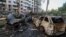 Burned-out cars lie strewn across a street on June 23 following a Russian strike on Kyiv. 